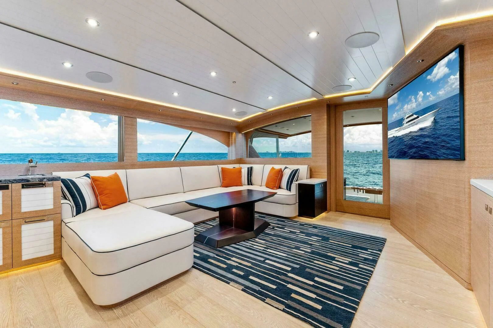 a living room with a couch and a table aboard III AMIGOS Yacht for Sale