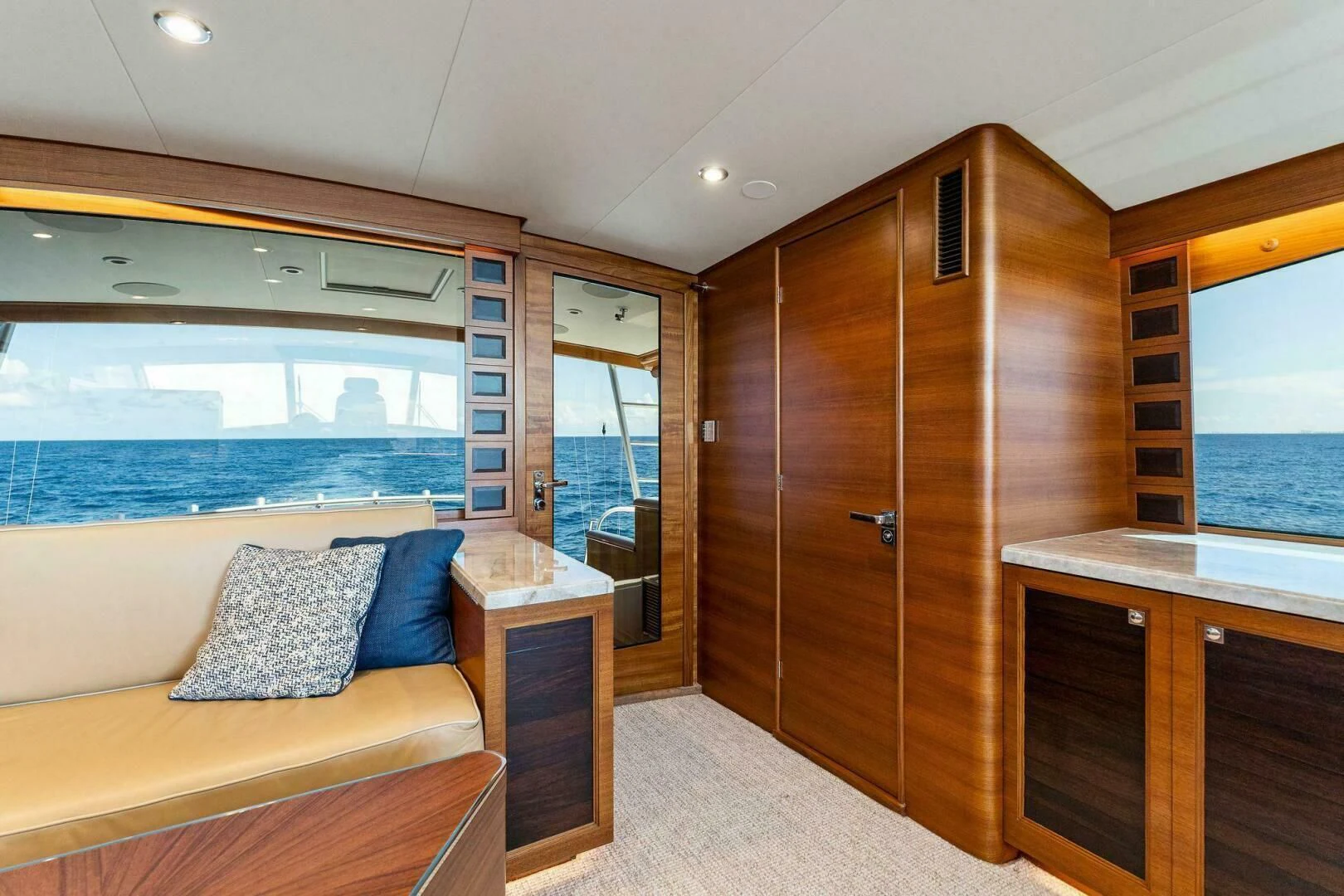 a bedroom with a bed and a wood cabinet aboard III AMIGOS Yacht for Sale