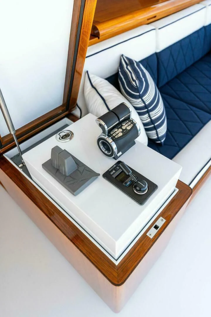 a bed with a white sheet and a blue and white striped pillow aboard III AMIGOS Yacht for Sale