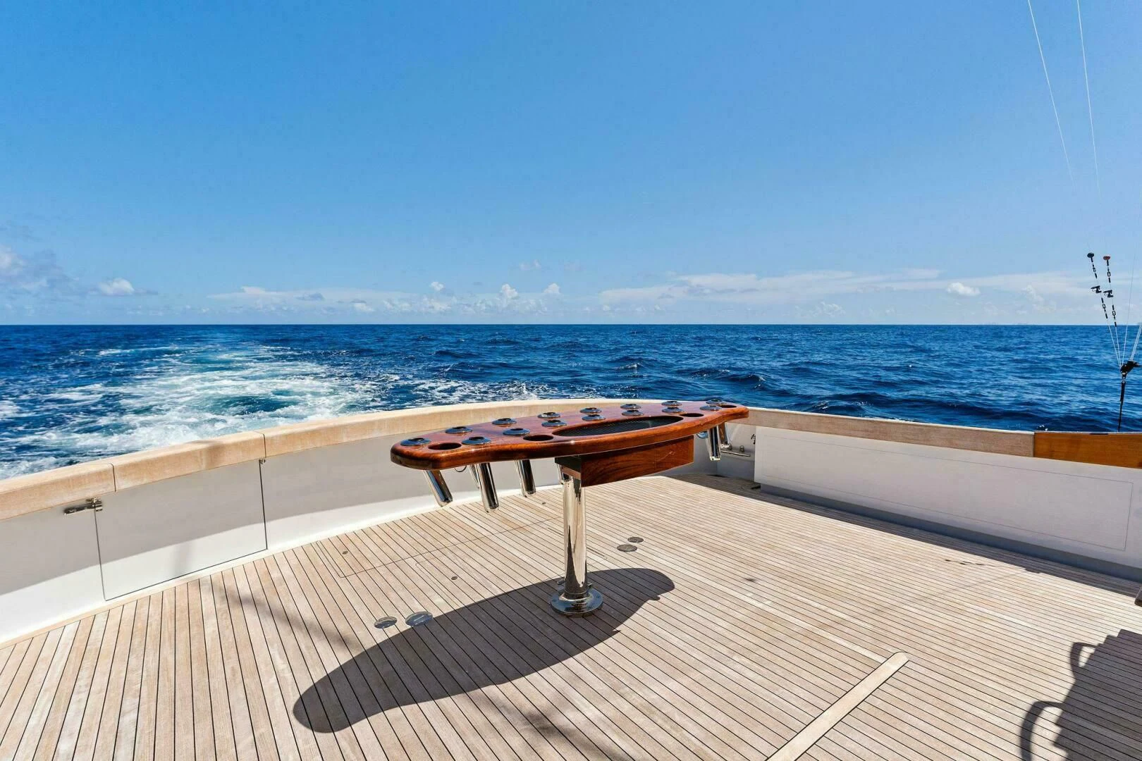 a table on a deck overlooking the ocean aboard III AMIGOS Yacht for Sale