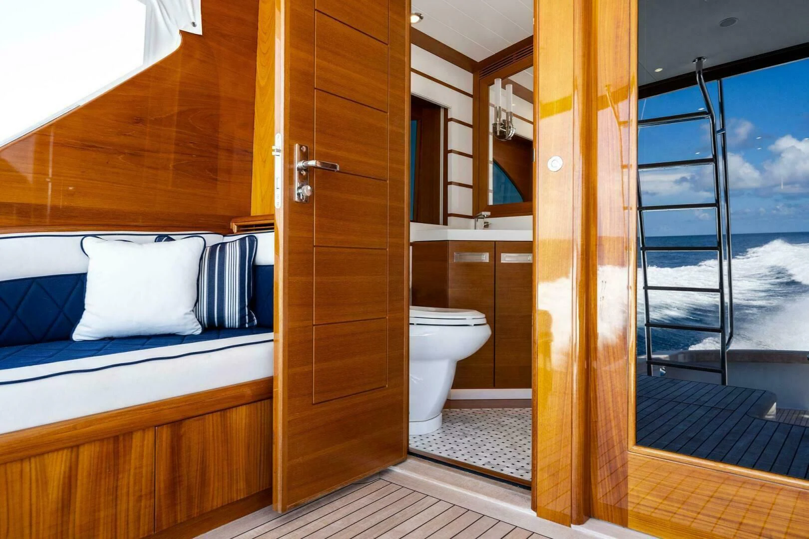 a room with a bed and a glass door aboard III AMIGOS Yacht for Sale