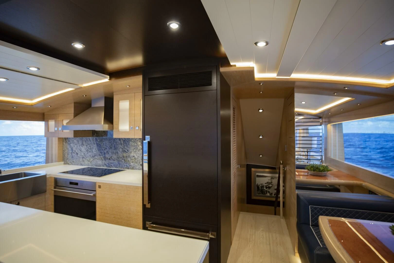 a kitchen with a large refrigerator aboard III AMIGOS Yacht for Sale