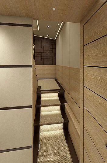 a hallway with a tile wall aboard III AMIGOS Yacht for Sale