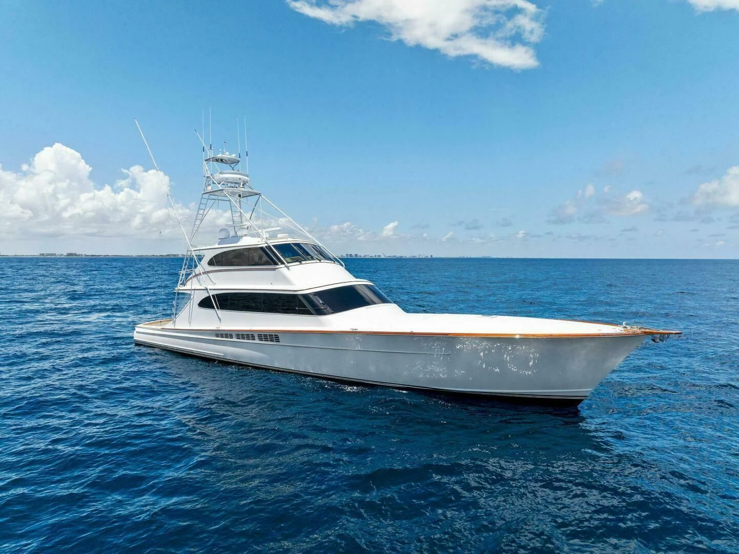 a white yacht in the water aboard III AMIGOS Yacht for Sale