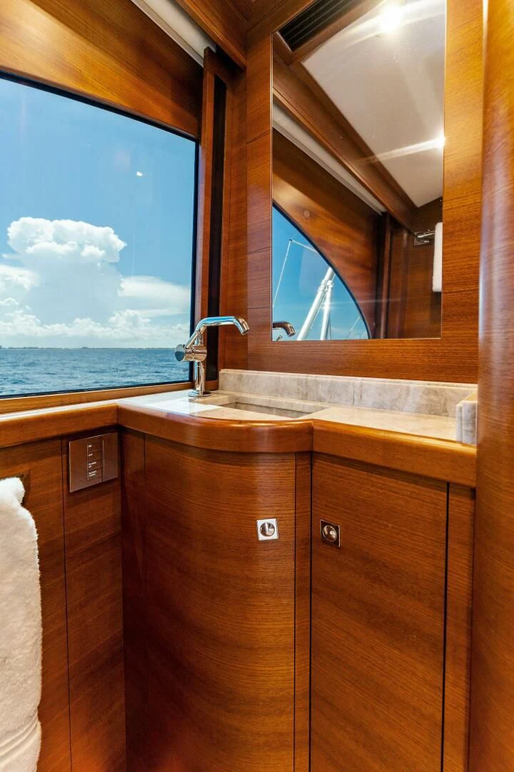 a bathroom with a large window aboard III AMIGOS Yacht for Sale