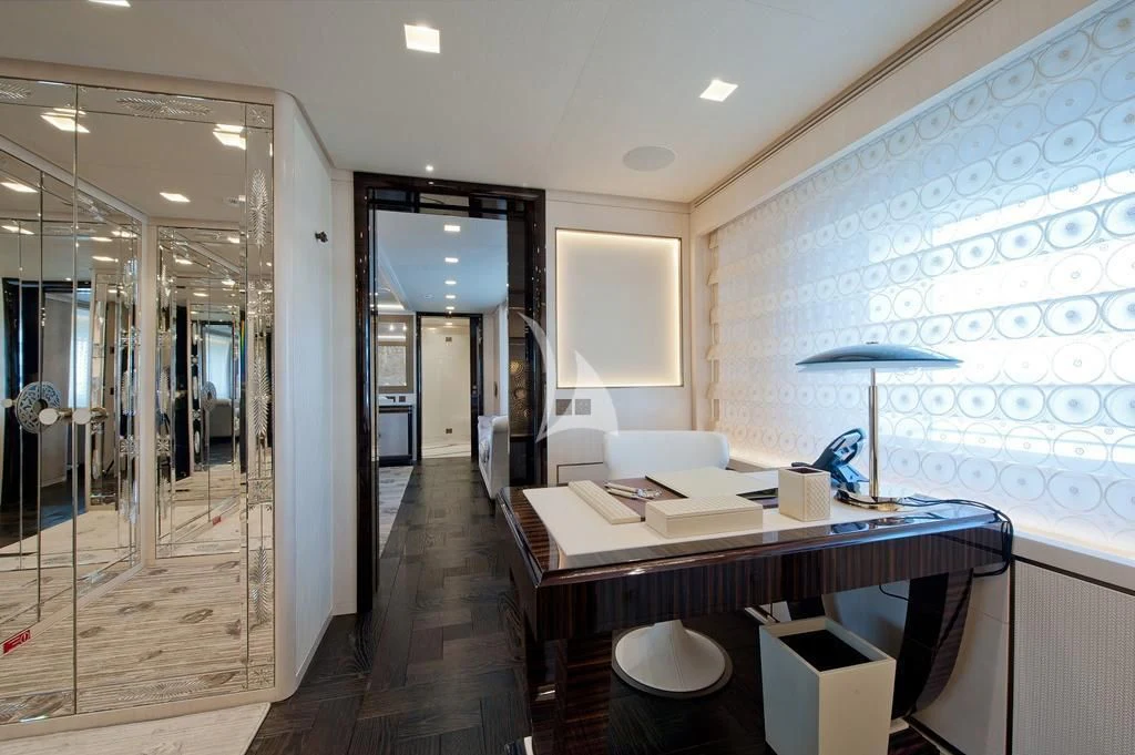 a room with a desk and a chair aboard SCORPION Yacht for Charter