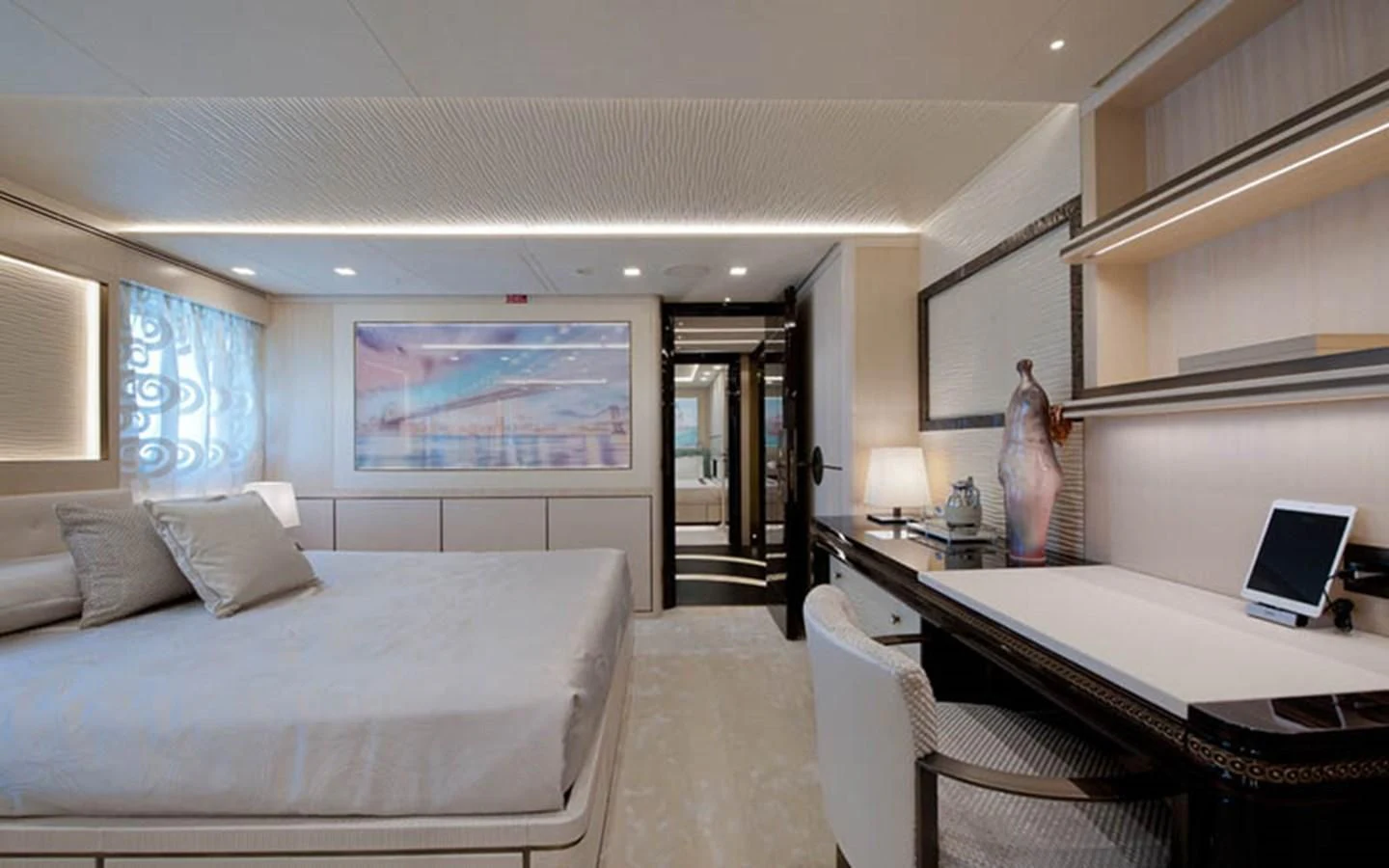 a bedroom with a bed and a desk aboard SCORPION Yacht for Charter