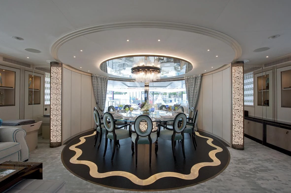 a dining room with a large chandelier aboard SCORPION Yacht for Charter