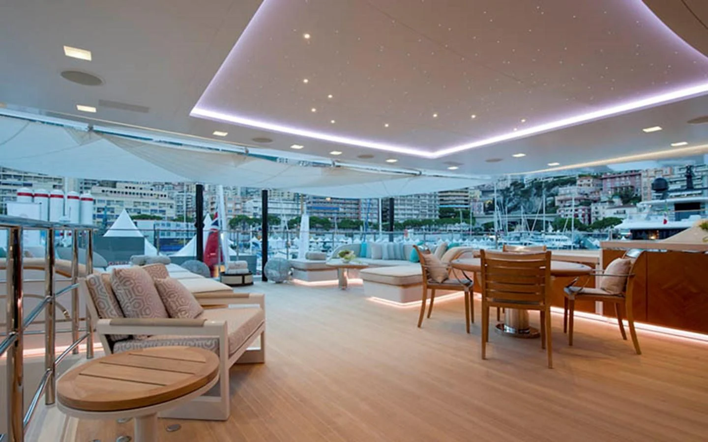 a room with a view of a city and a large pool aboard SCORPION Yacht for Charter