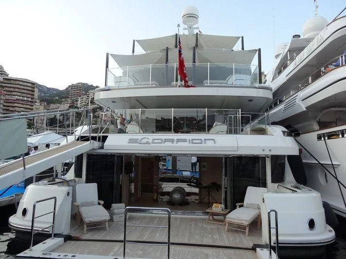 a boat docked at a pier aboard SCORPION Yacht for Charter