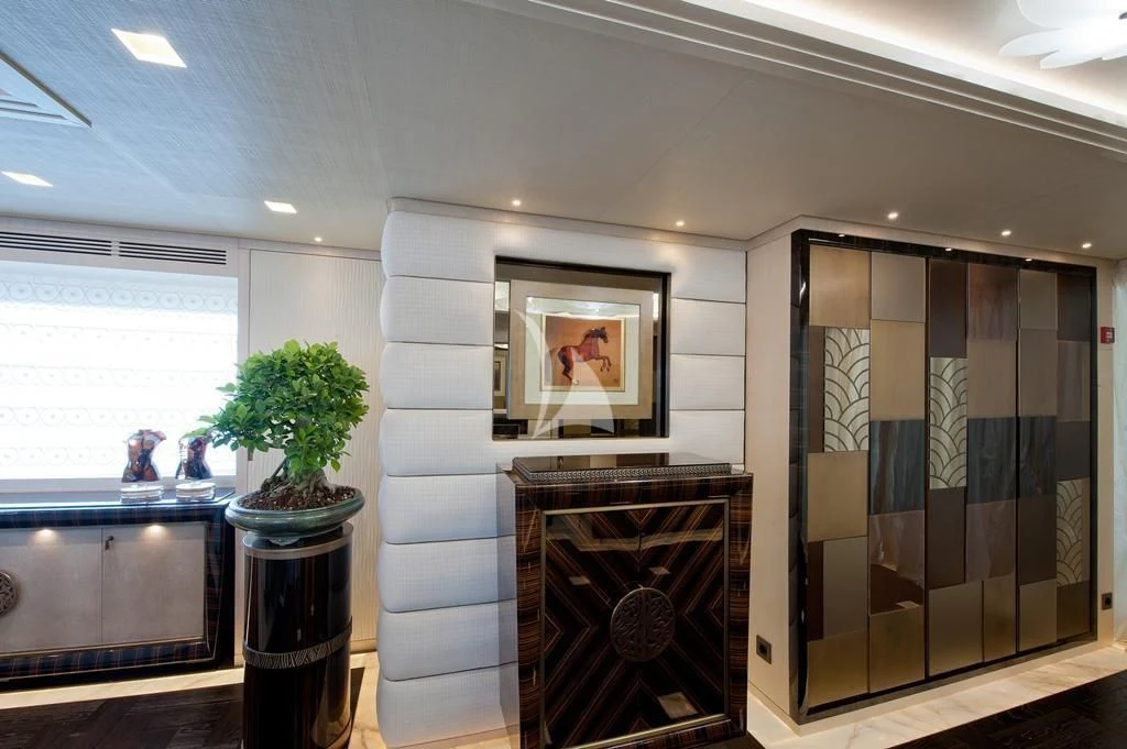 a room with a fireplace and a glass door aboard SCORPION Yacht for Charter