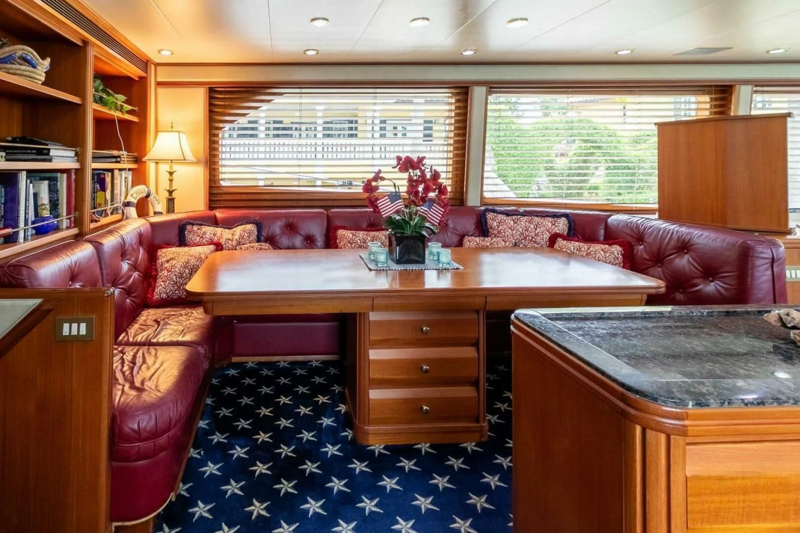 a living room with a table and couches aboard CHAIRMAN Yacht for Sale