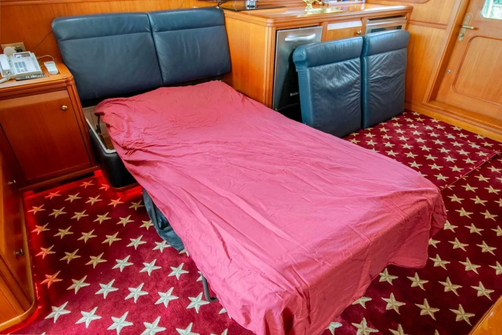 a bed with a pink comforter aboard CHAIRMAN Yacht for Sale