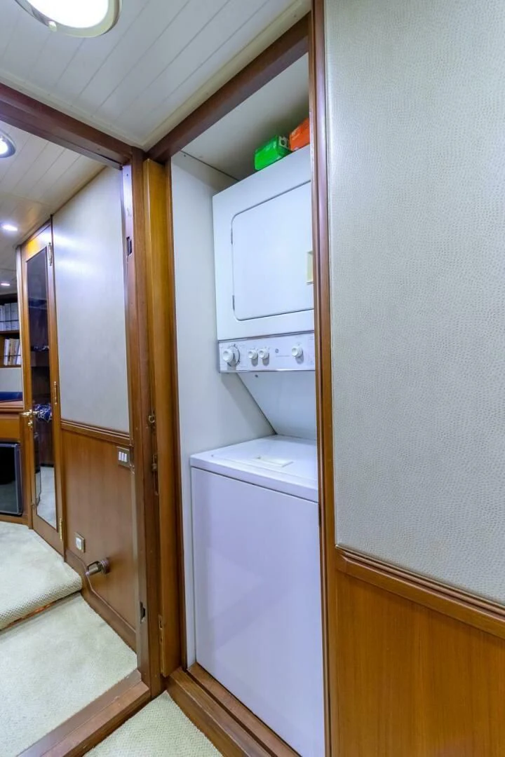 a small bathroom with a closet aboard CHAIRMAN Yacht for Sale