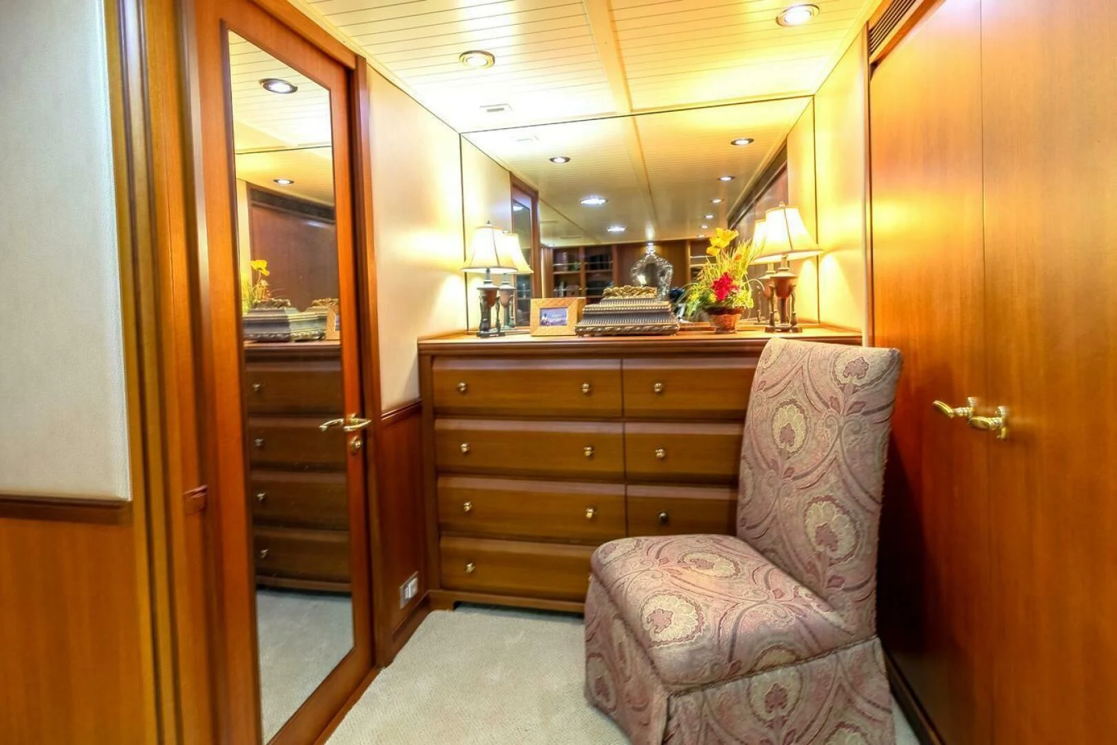 a chair and a dresser in a room aboard CHAIRMAN Yacht for Sale