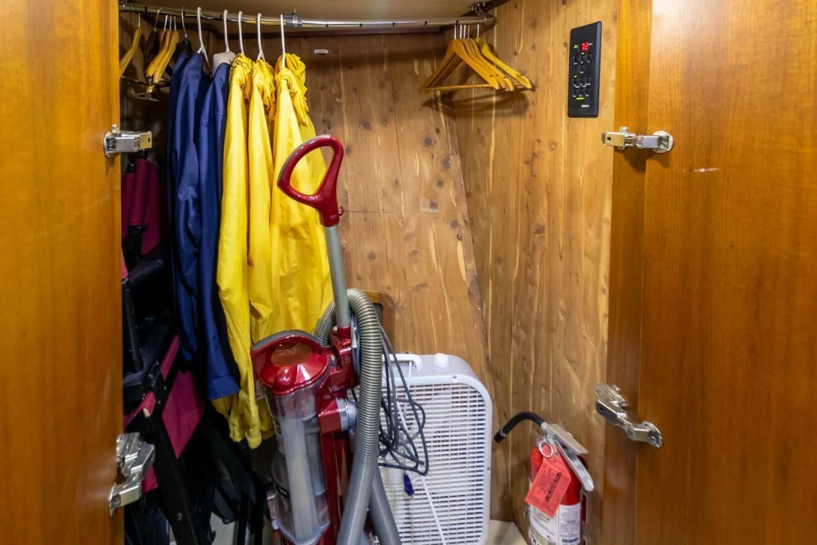 a closet with clothes and items aboard CHAIRMAN Yacht for Sale