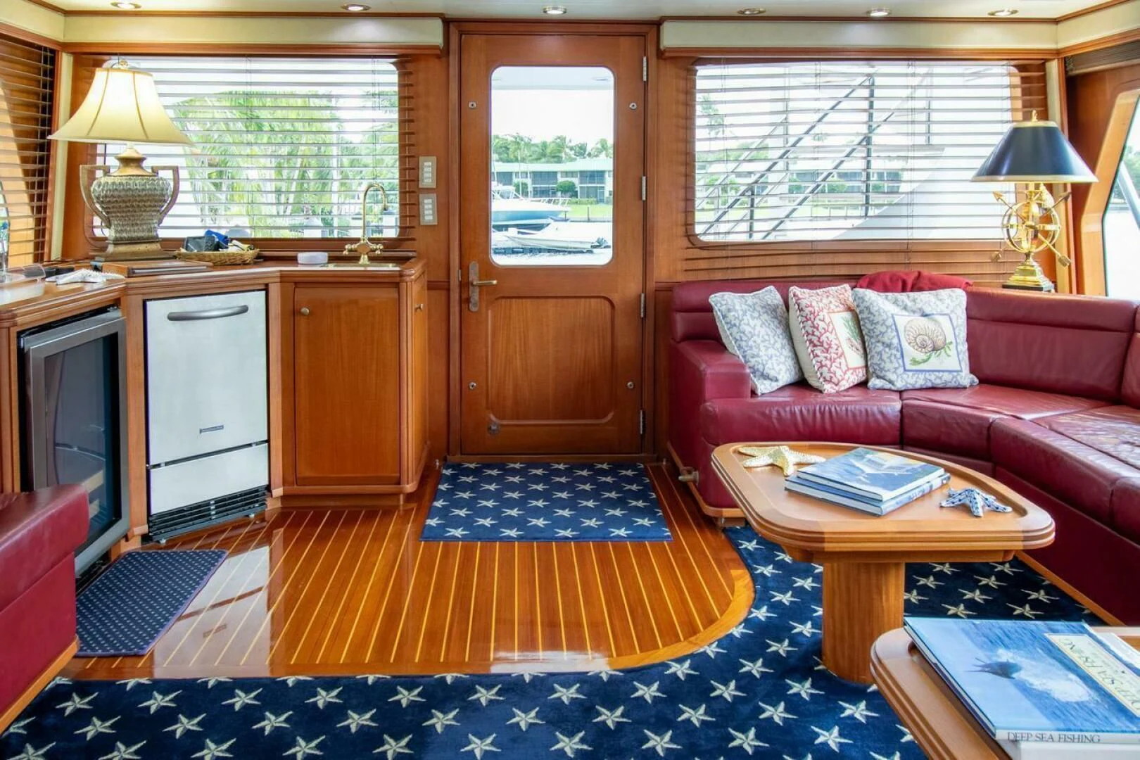 a living room with a red couch aboard CHAIRMAN Yacht for Sale