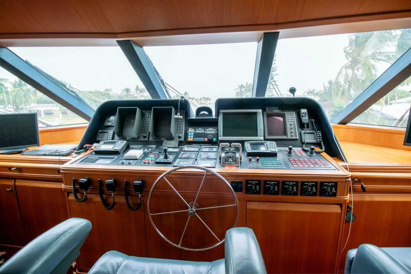 a wooden desk with a computer and other electronic devices on it aboard CHAIRMAN Yacht for Sale