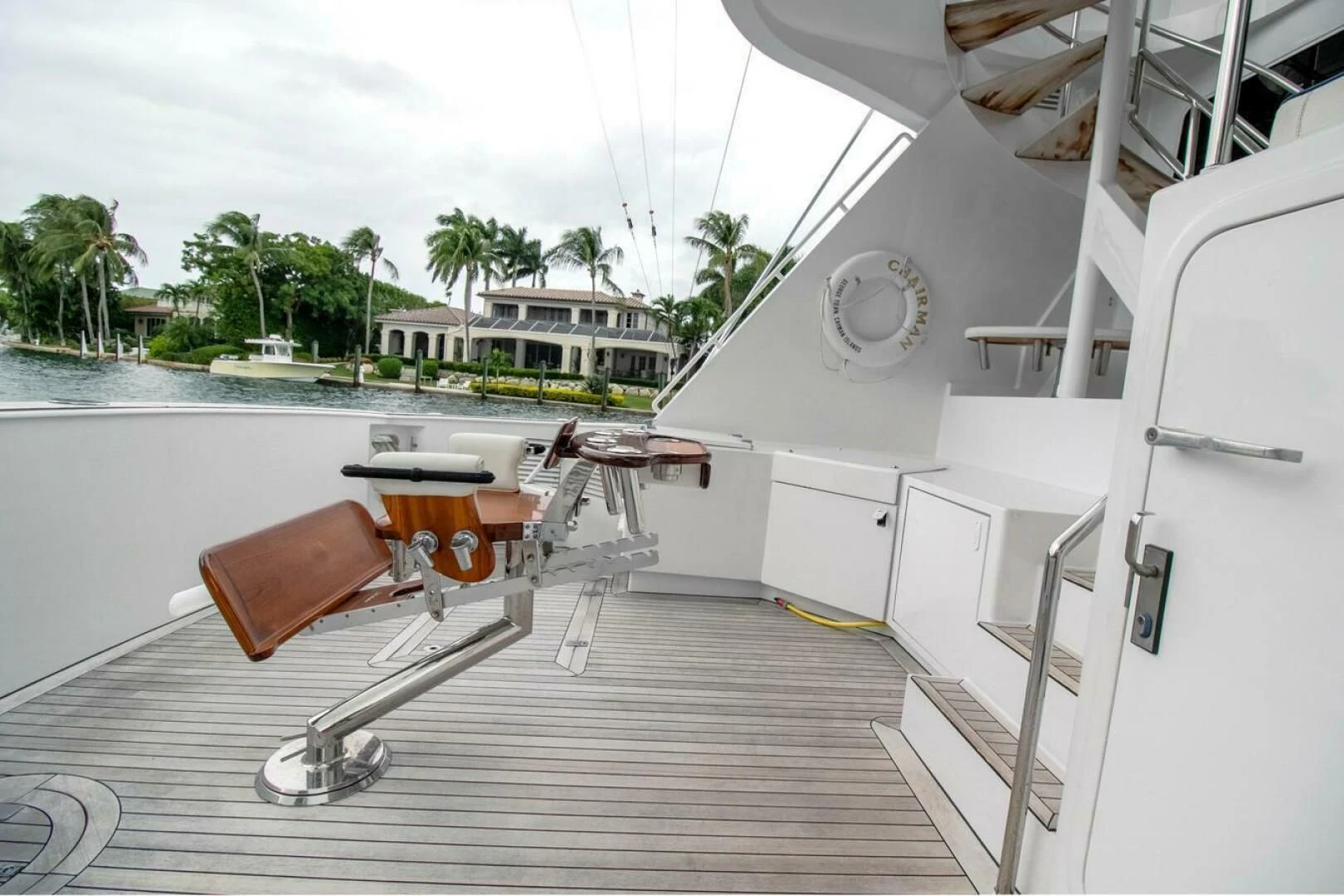 a deck with a table and chairs on it aboard CHAIRMAN Yacht for Sale
