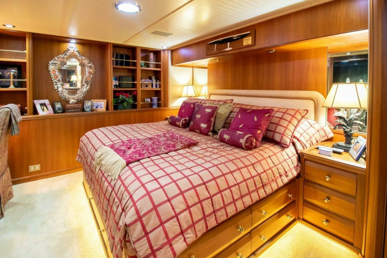 a bed with colorful pillows aboard CHAIRMAN Yacht for Sale
