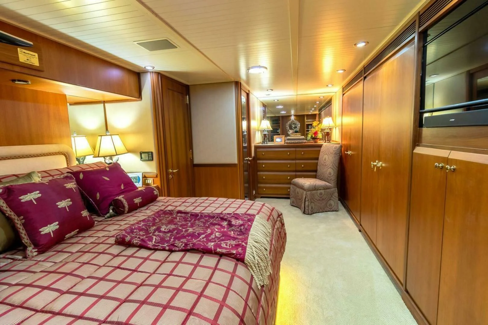 a bedroom with a bed and a chair aboard CHAIRMAN Yacht for Sale