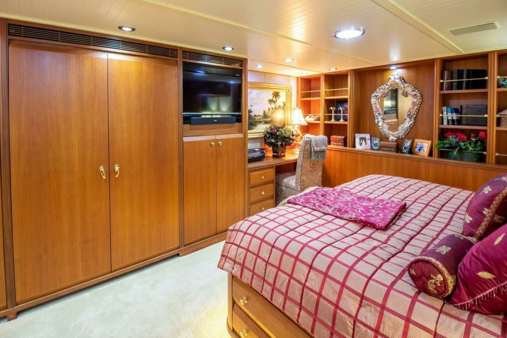 a bedroom with a bed and cabinets aboard CHAIRMAN Yacht for Sale