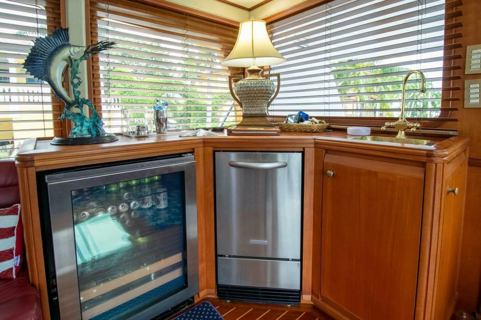 a television on a cabinet in a room with a window aboard CHAIRMAN Yacht for Sale