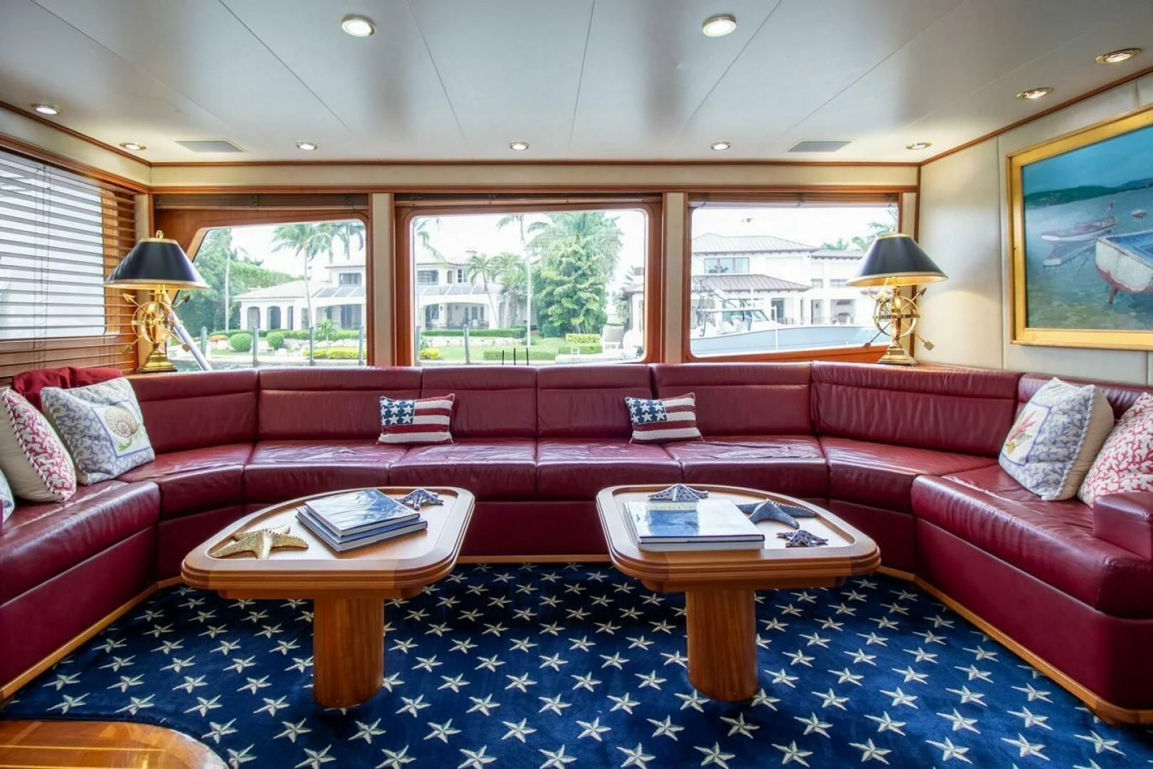 a living room with a red couch aboard CHAIRMAN Yacht for Sale