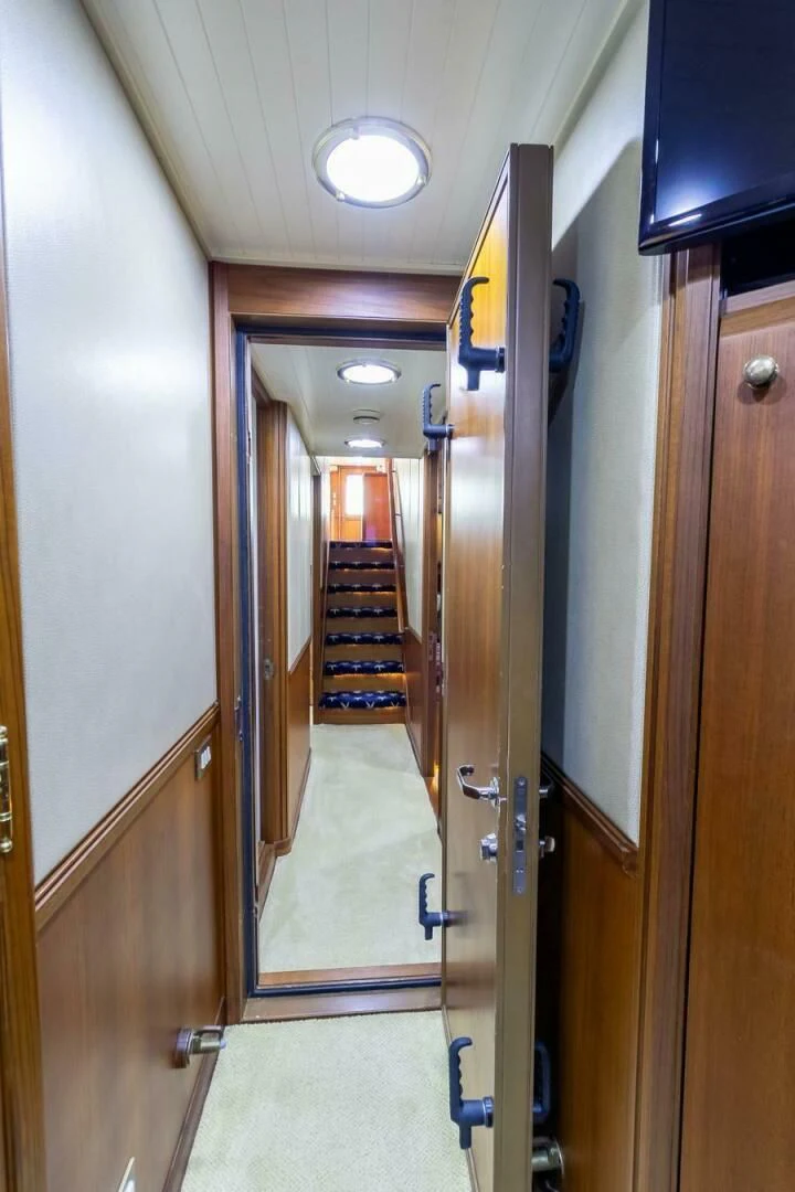 a hallway with a door and a mirror aboard CHAIRMAN Yacht for Sale
