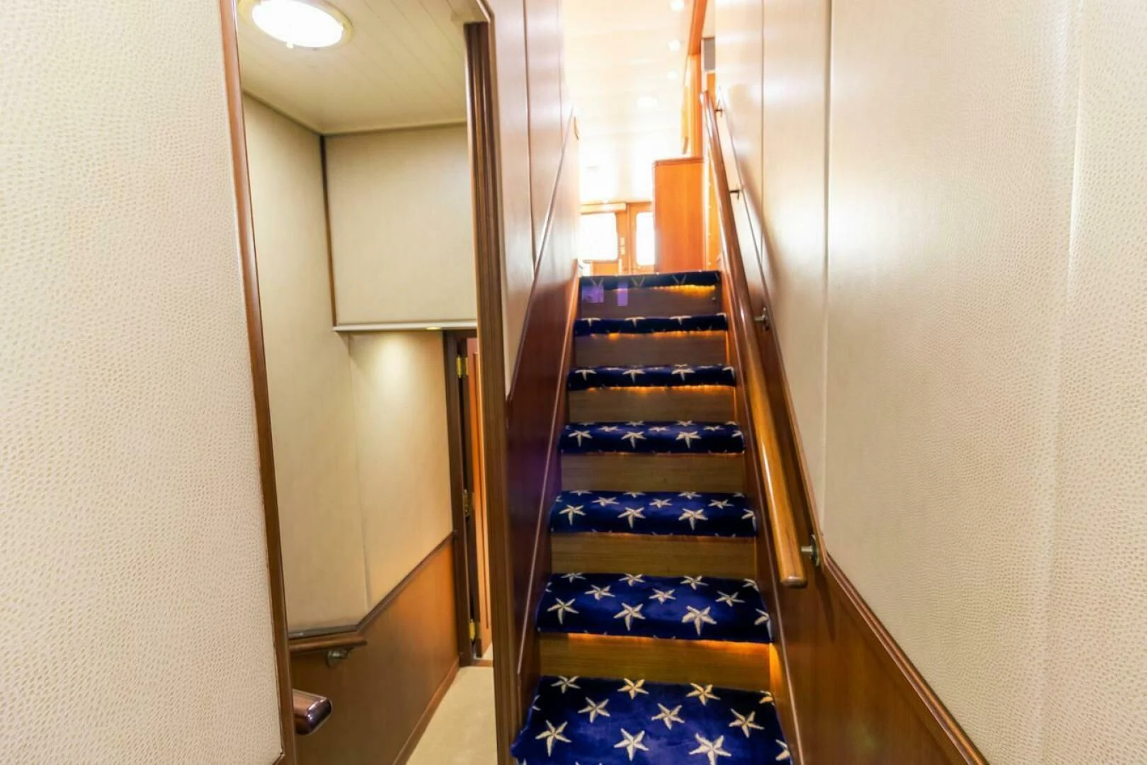 a staircase with a blue carpet aboard CHAIRMAN Yacht for Sale