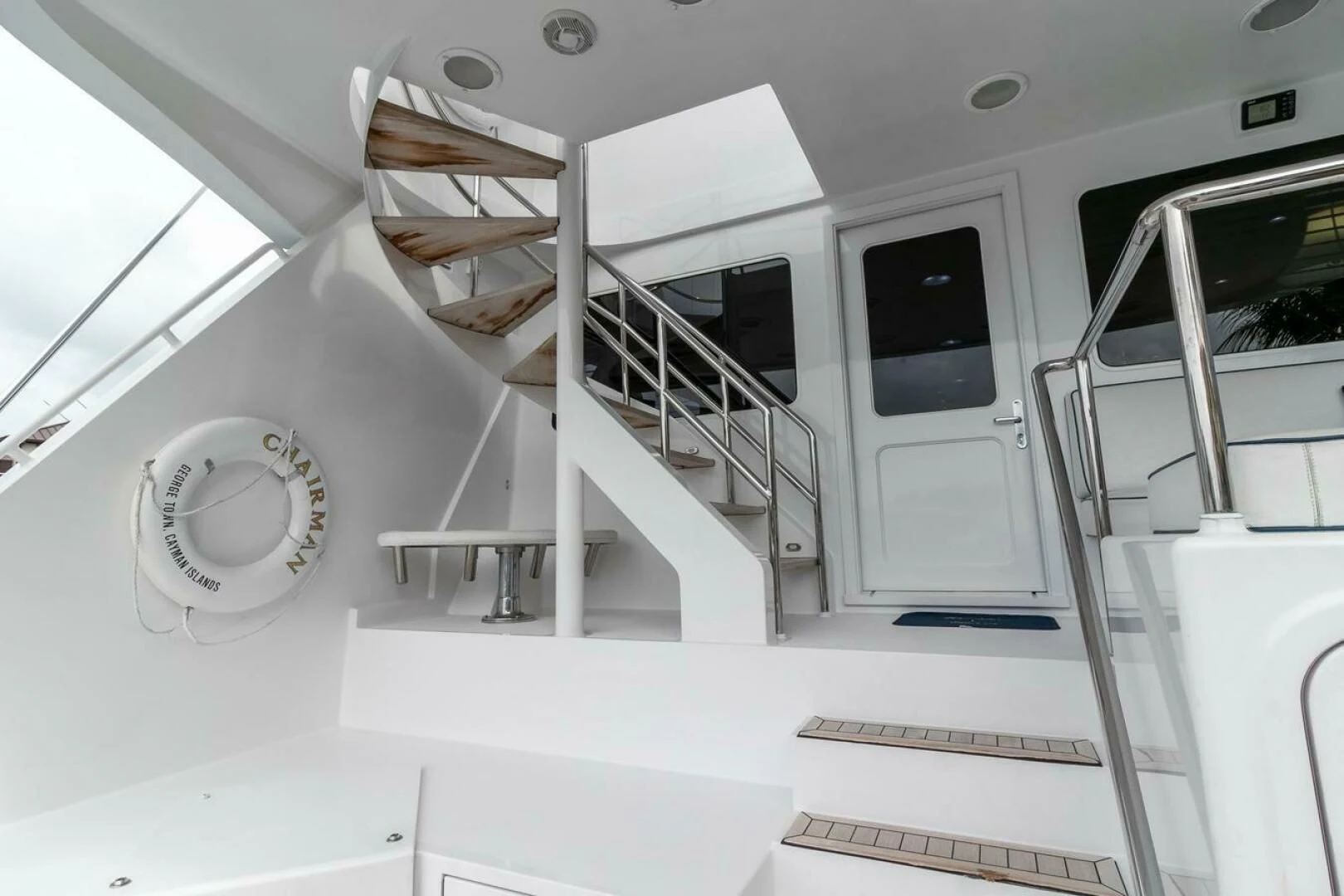 a white room with a staircase and a window aboard CHAIRMAN Yacht for Sale