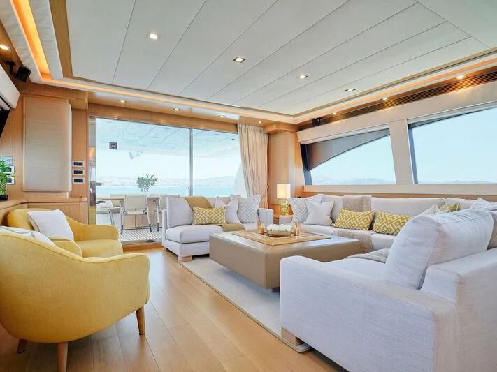 a living room with white couches aboard JULIE M Yacht for Sale
