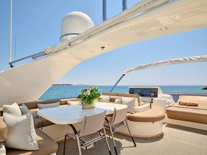 a room with a table and chairs aboard JULIE M Yacht for Sale