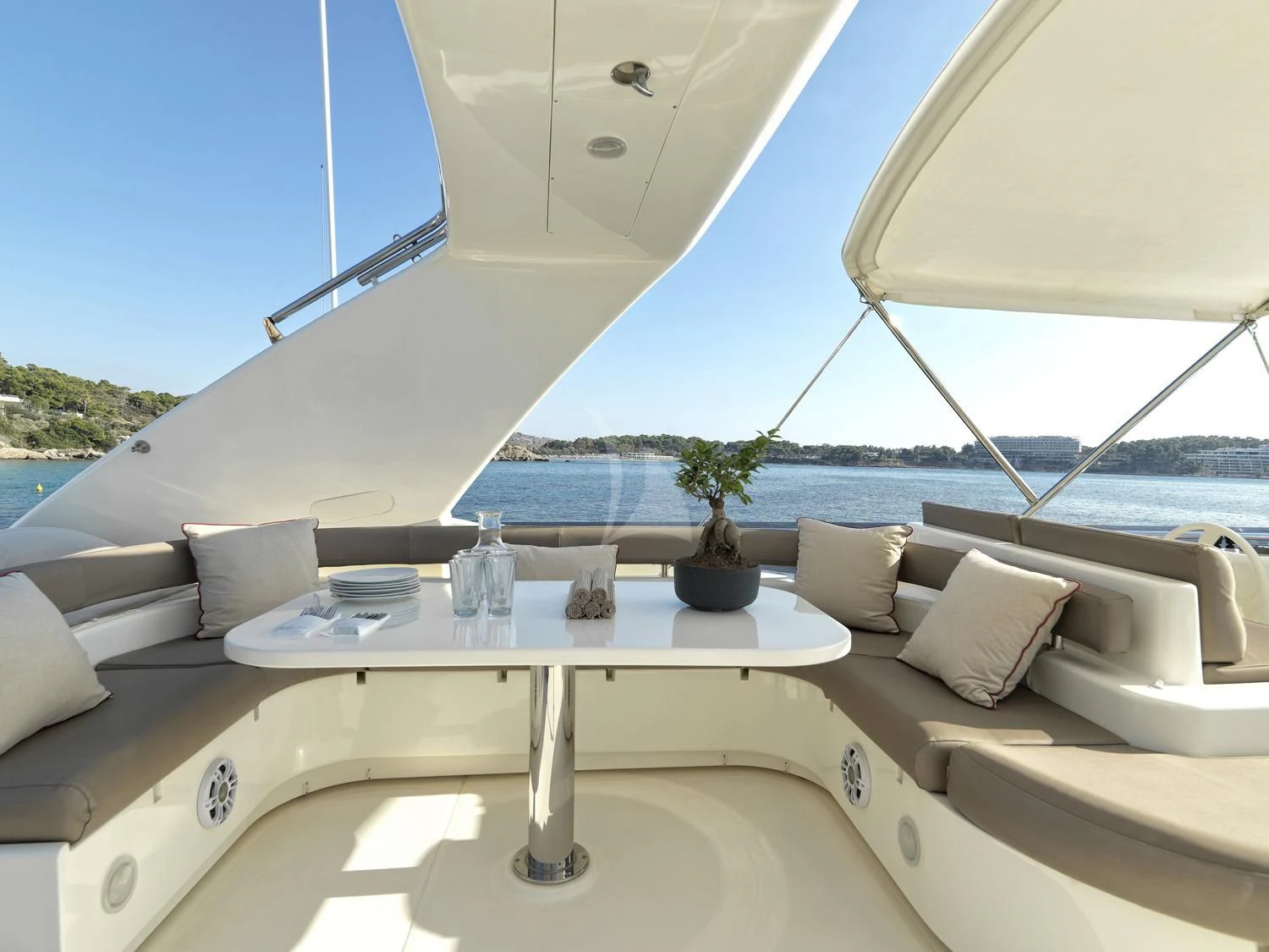 a room with a bed and a table with a view of the ocean aboard JULIE M Yacht for Sale