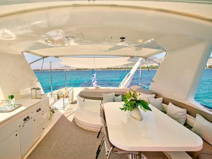 a room with a table and chairs and a large swimming pool aboard JULIE M Yacht for Sale