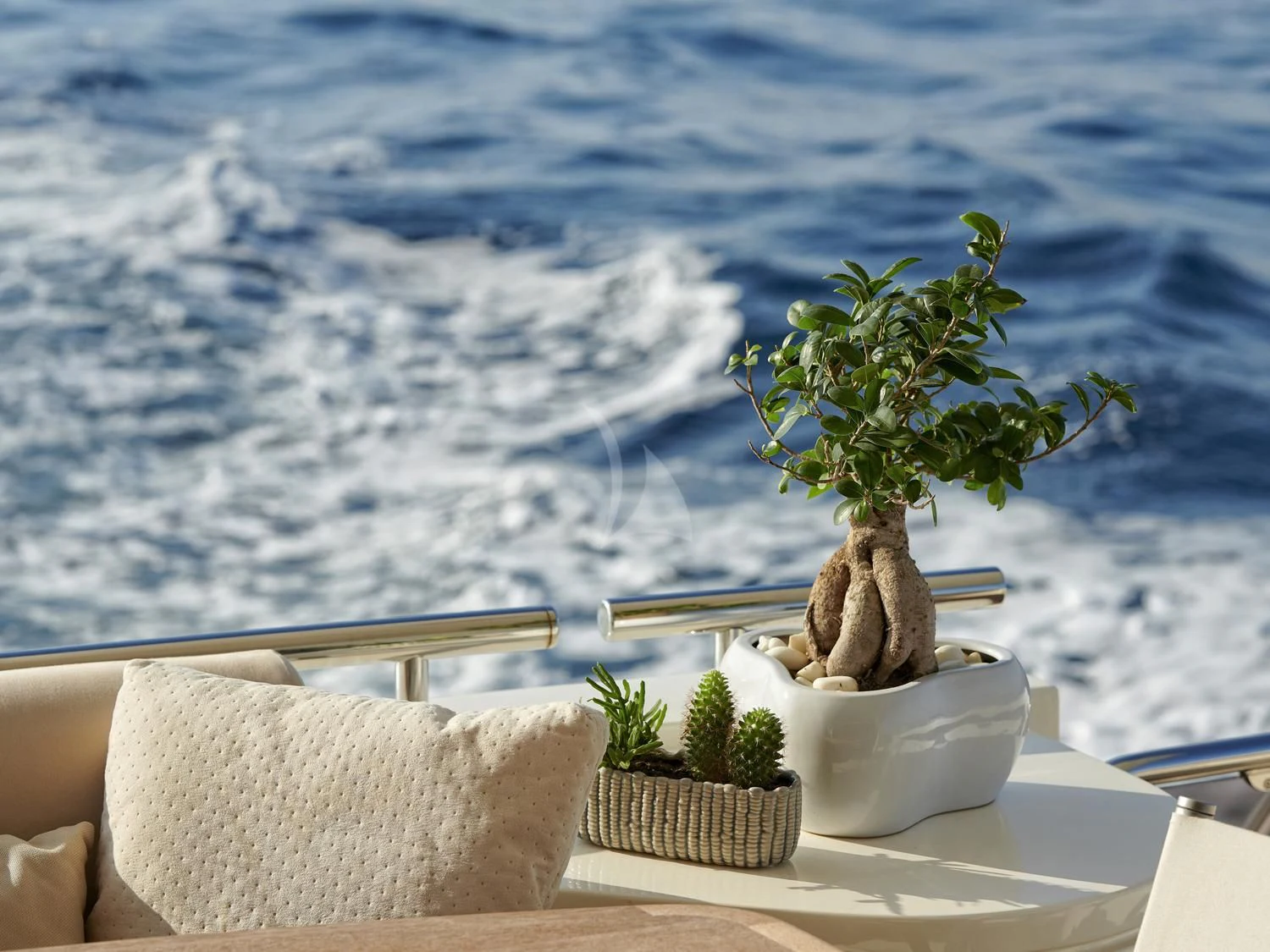 a small plant in a pot on a table with a white cloth and a white chair with a aboard JULIE M Yacht for Sale
