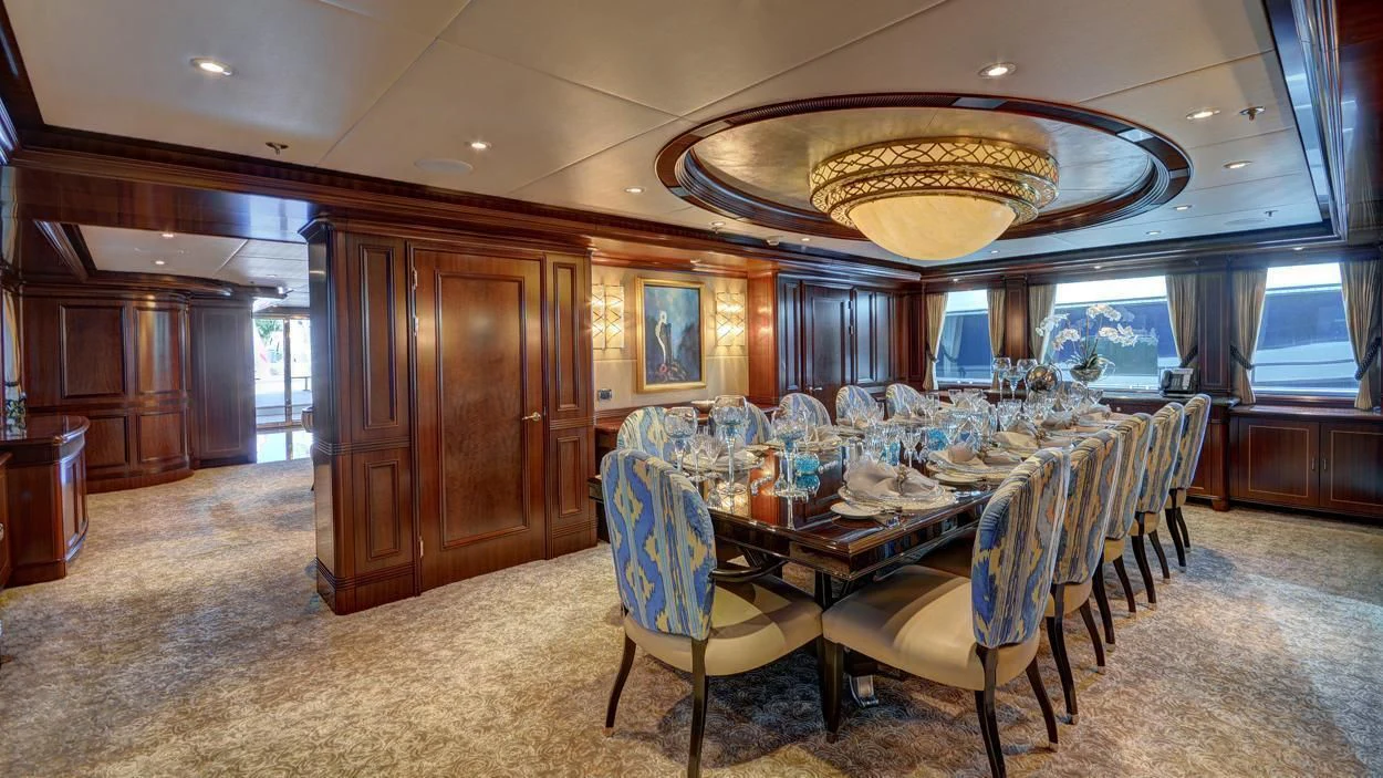 a dining room with a large chandelier aboard LADY BETH Yacht for Sale