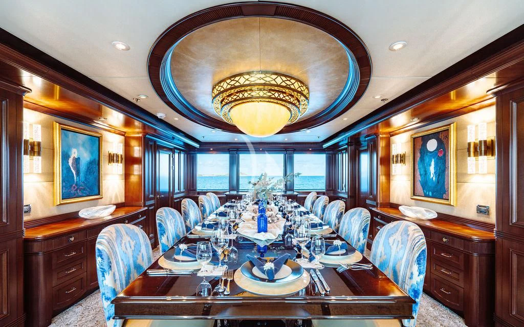a large dining room with a large chandelier aboard LADY BETH Yacht for Sale