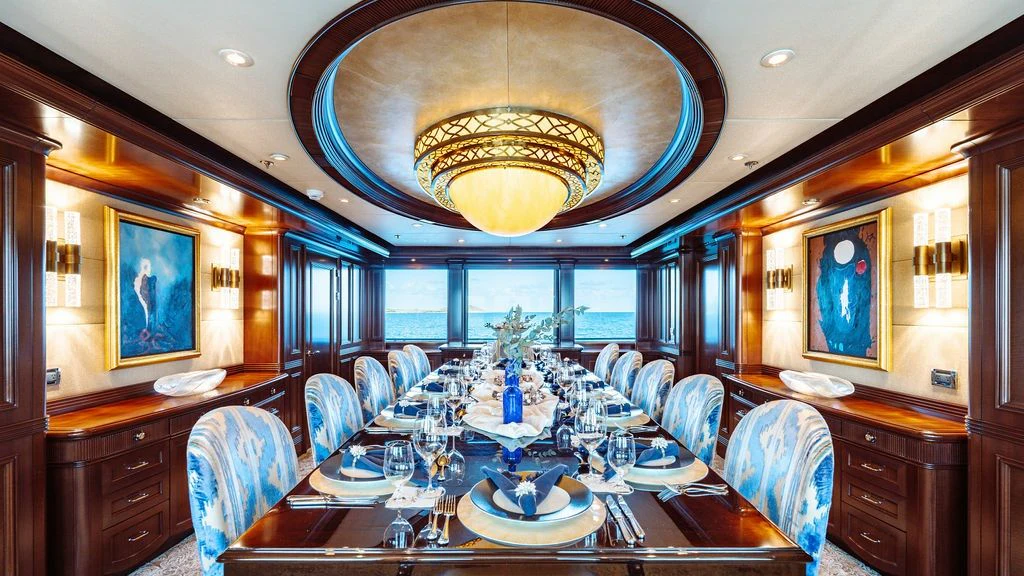 a large dining room with a large chandelier aboard LADY BETH Yacht for Sale