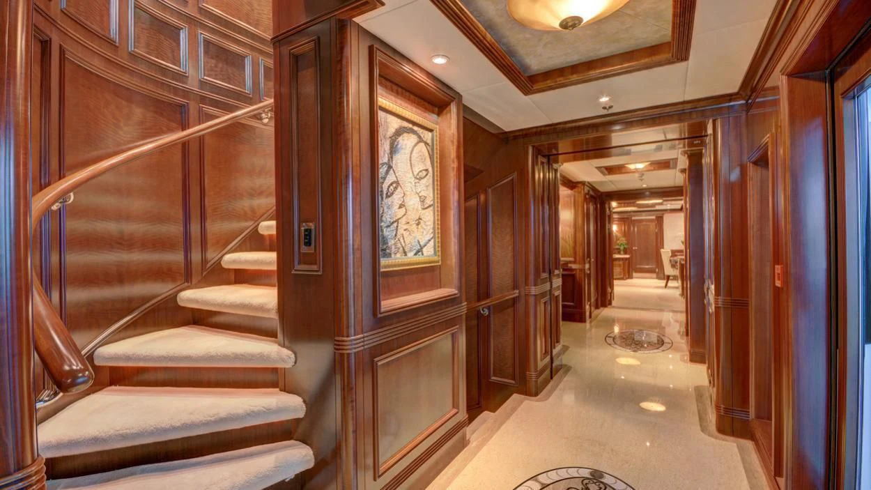 a hallway with a door and a staircase aboard LADY BETH Yacht for Sale