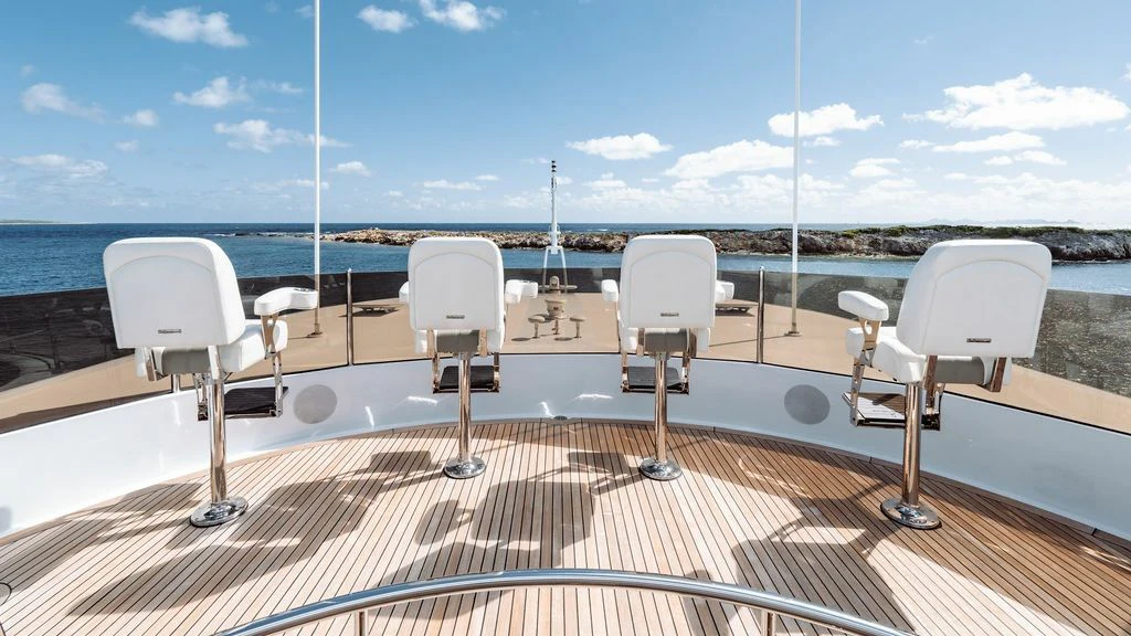 a deck with chairs and a view of the ocean aboard LADY BETH Yacht for Sale