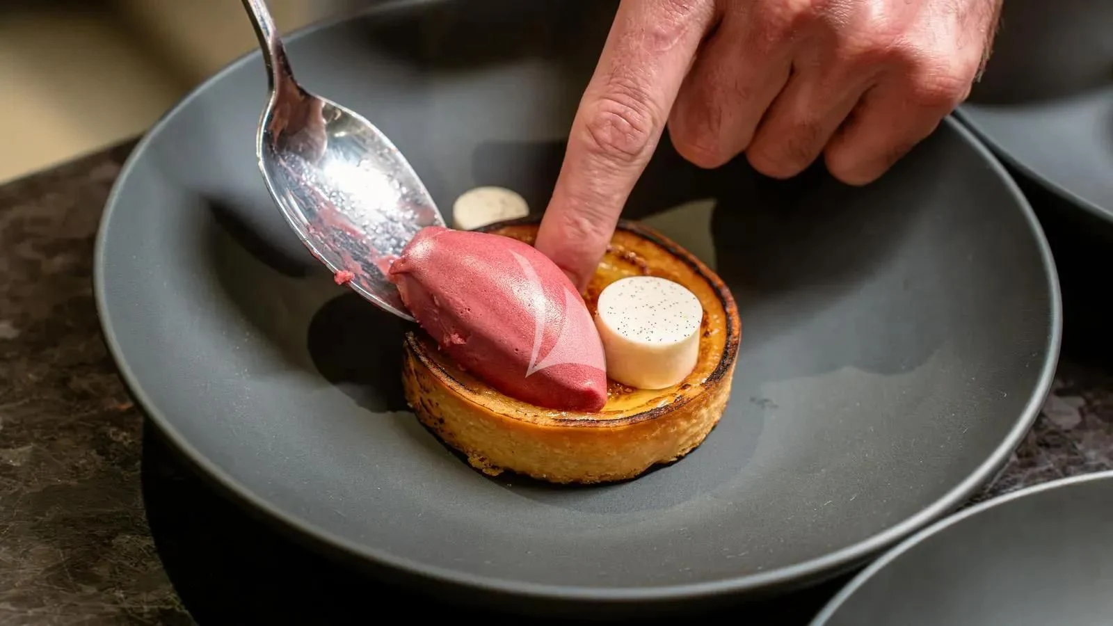 a person holding a spoon over a bowl of food aboard LADY BETH Yacht for Sale