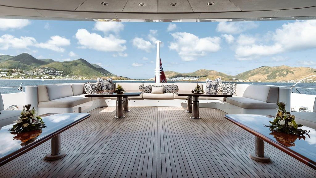 a deck with a table and chairs aboard LADY BETH Yacht for Sale