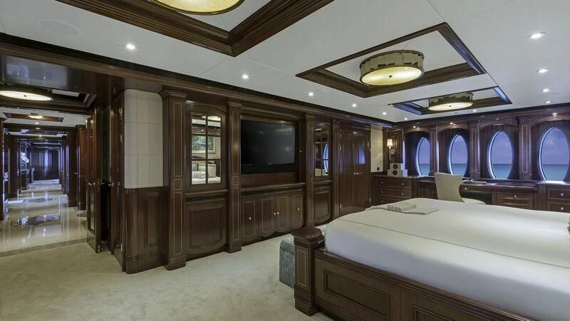 a bedroom with a bed and a television aboard LADY BETH Yacht for Sale