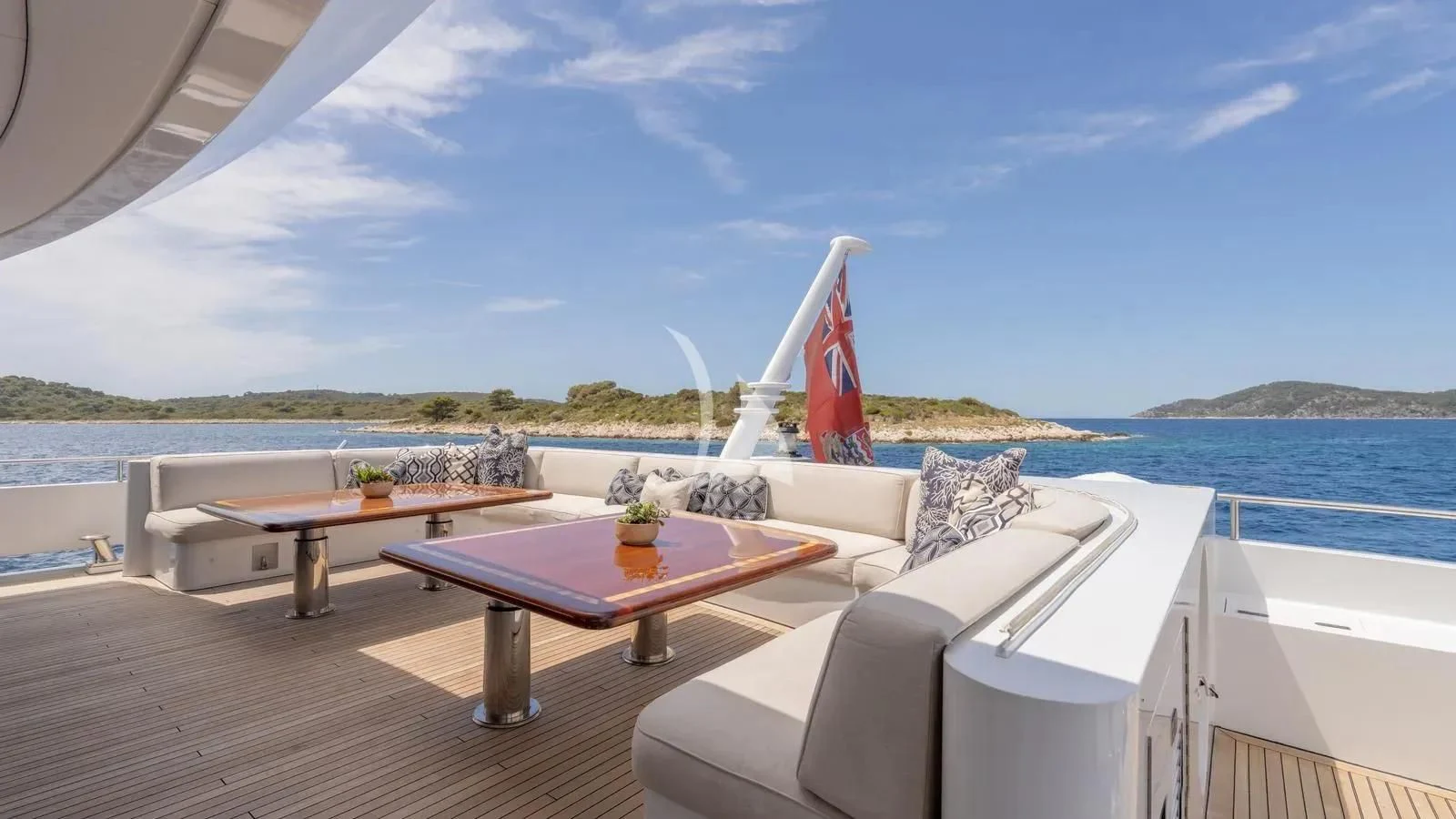 a table and chairs on a deck overlooking a body of water aboard LADY BETH Yacht for Sale