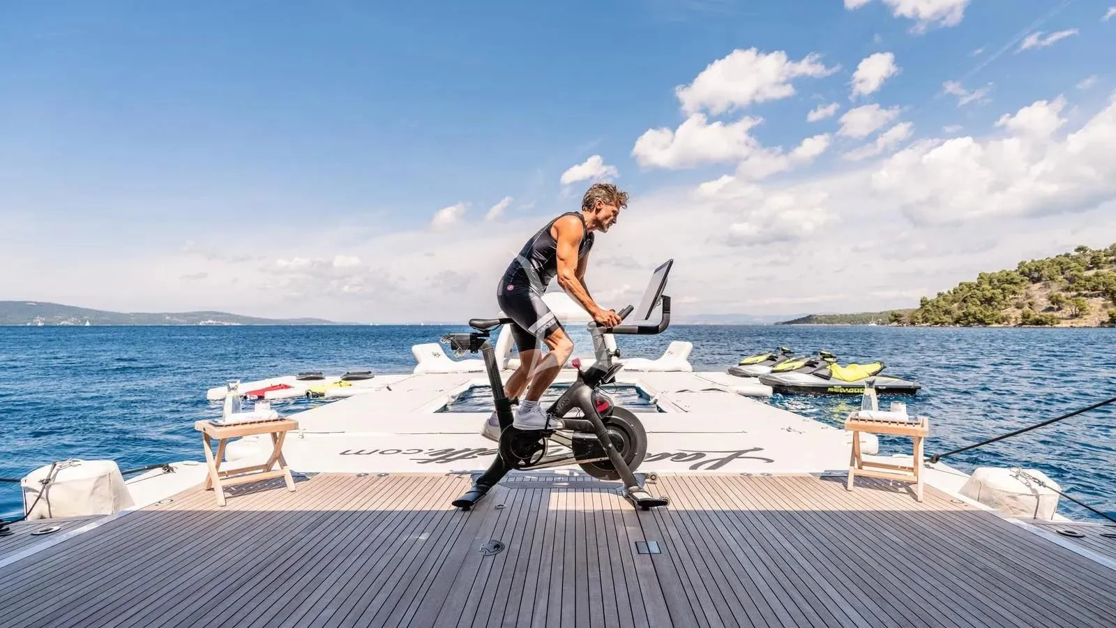 a man on a bicycle on a dock by a body of water aboard LADY BETH Yacht for Sale