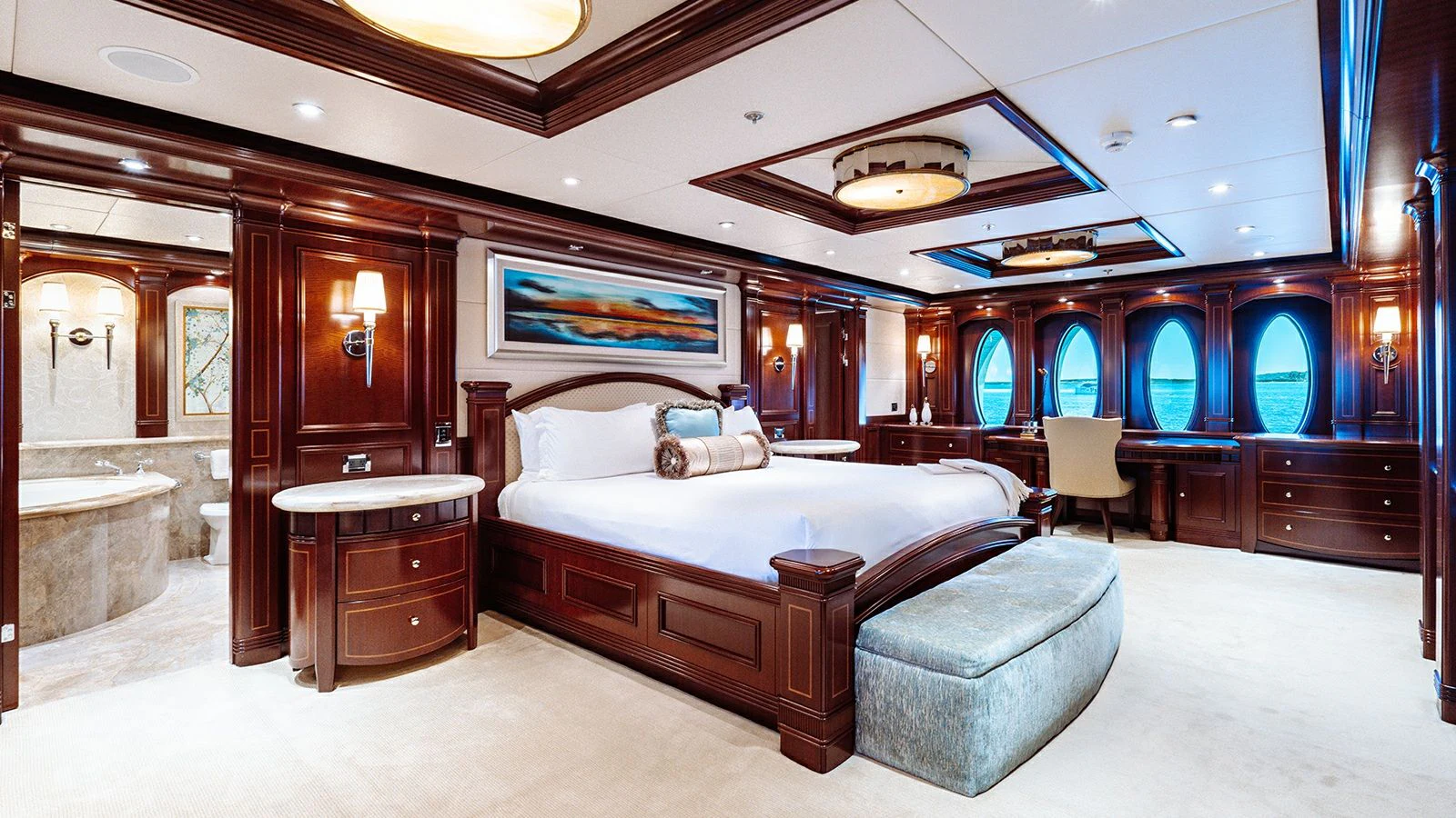 a large bedroom with a bed and a large mirror aboard LADY BETH Yacht for Sale
