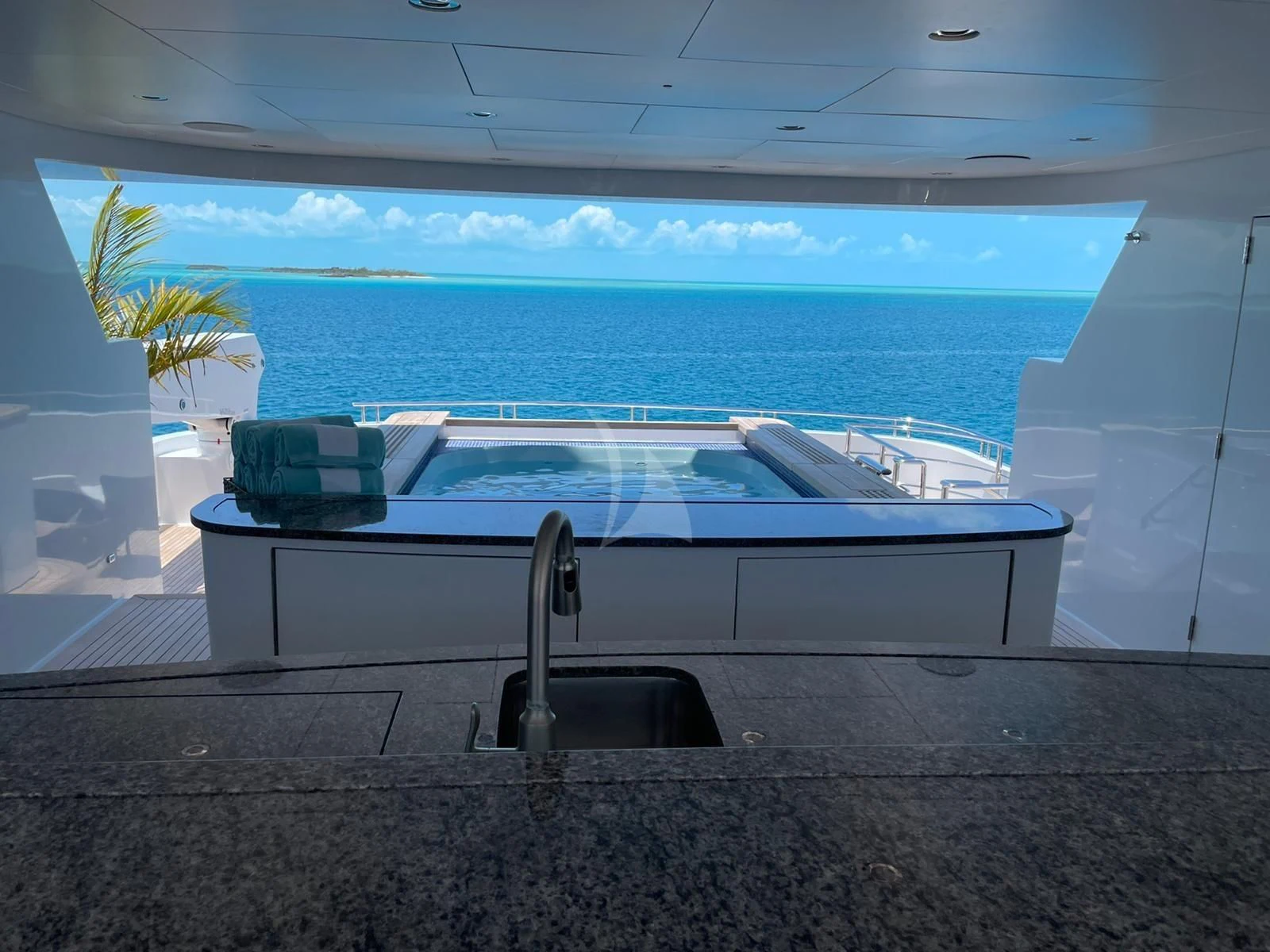 a pool with a bar and a chair on the deck aboard LADY BETH Yacht for Sale