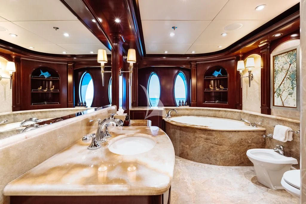 a bathroom with a large bathtub and sinks aboard LADY BETH Yacht for Sale