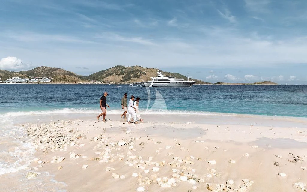 a group of people walking on a beach aboard LADY BETH Yacht for Sale